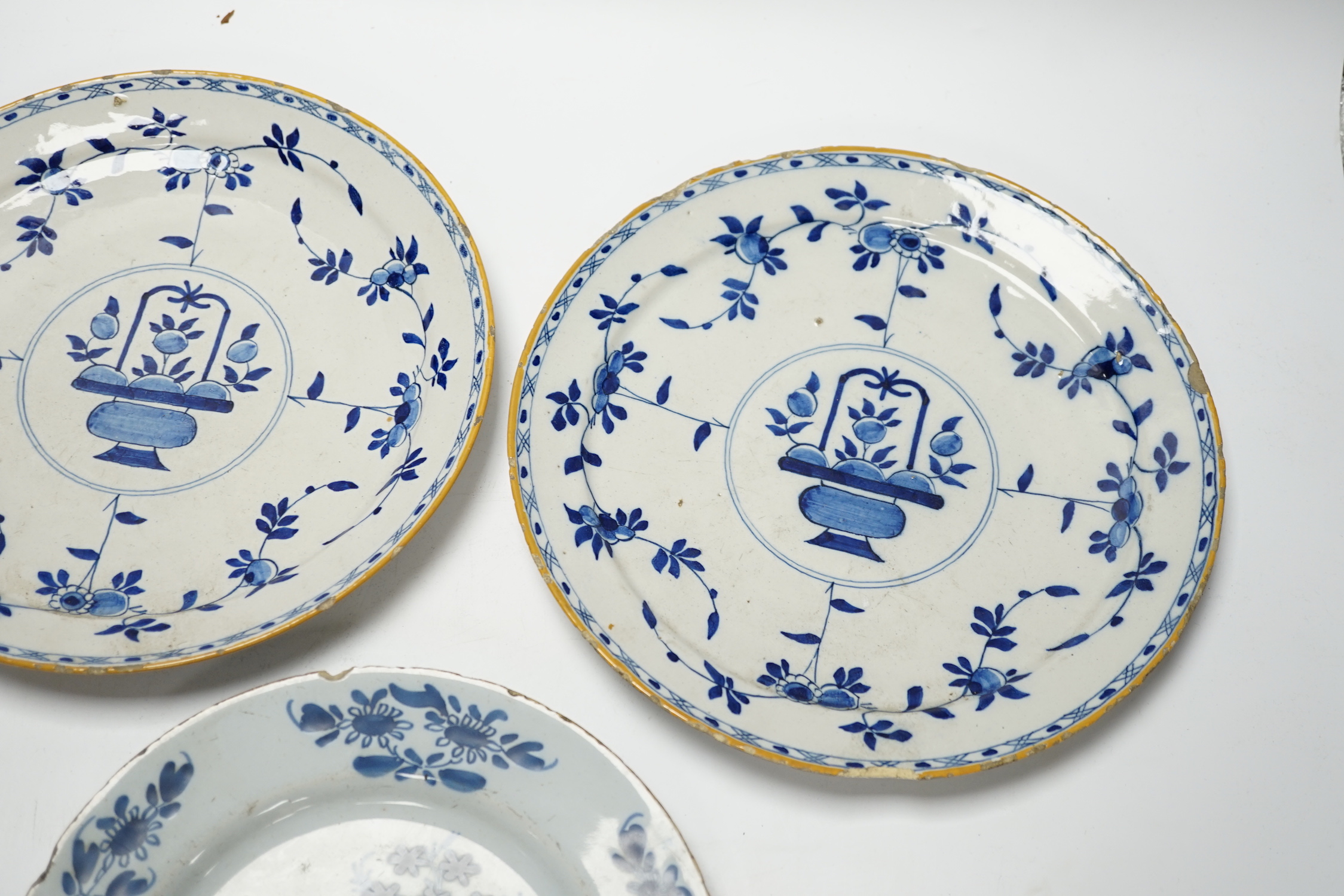 A pair of late 18th century Delft plates and an English delftware plate (3)